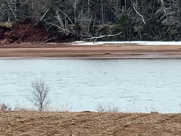 Red cliff edge across open water
